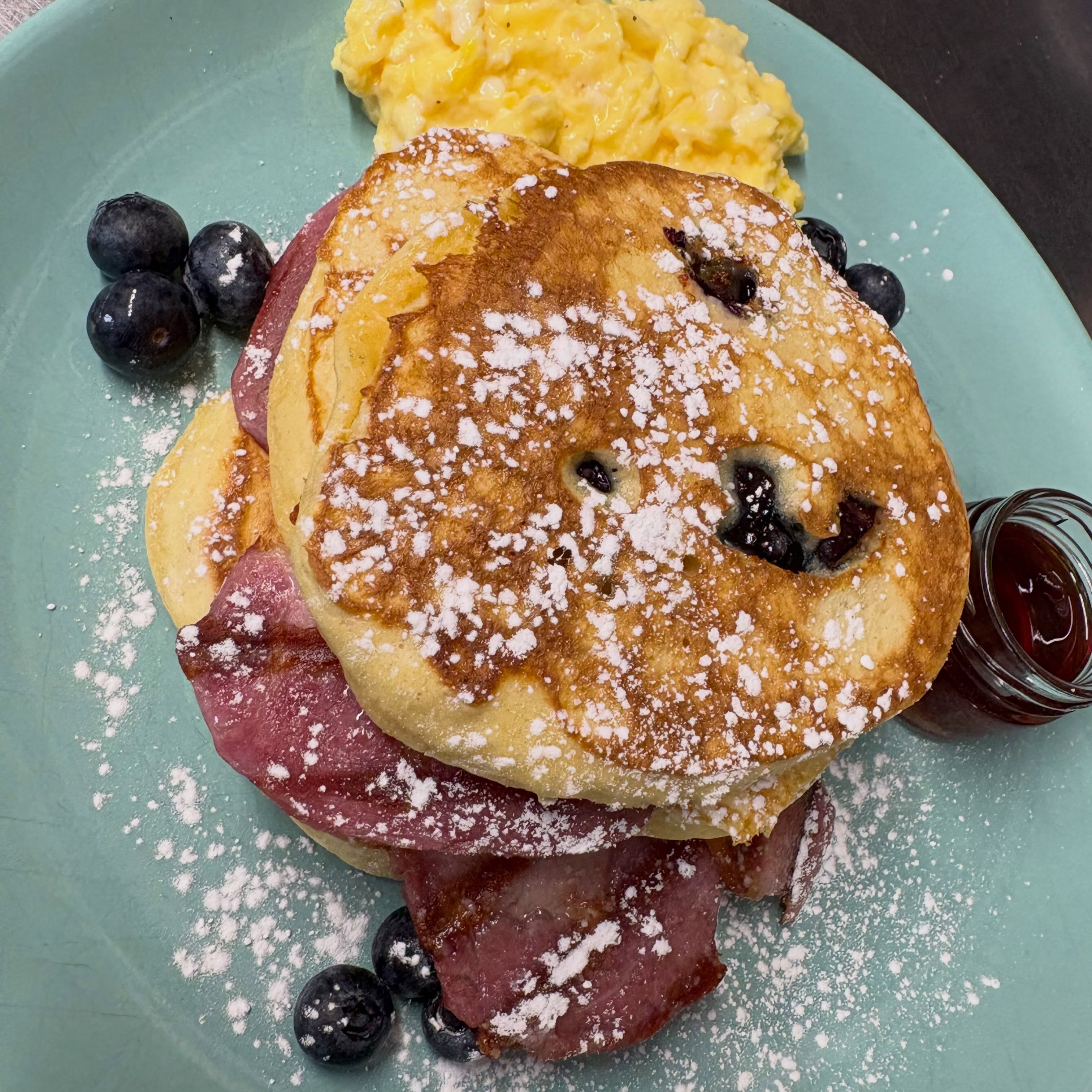 Lulamae’s breakfast photograph showing pancakes and scrambled eggs on a pale green plate